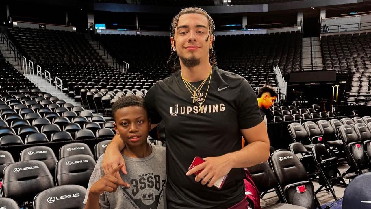 Xaviel Rodriguez with a young HOOPS for HOPE camper