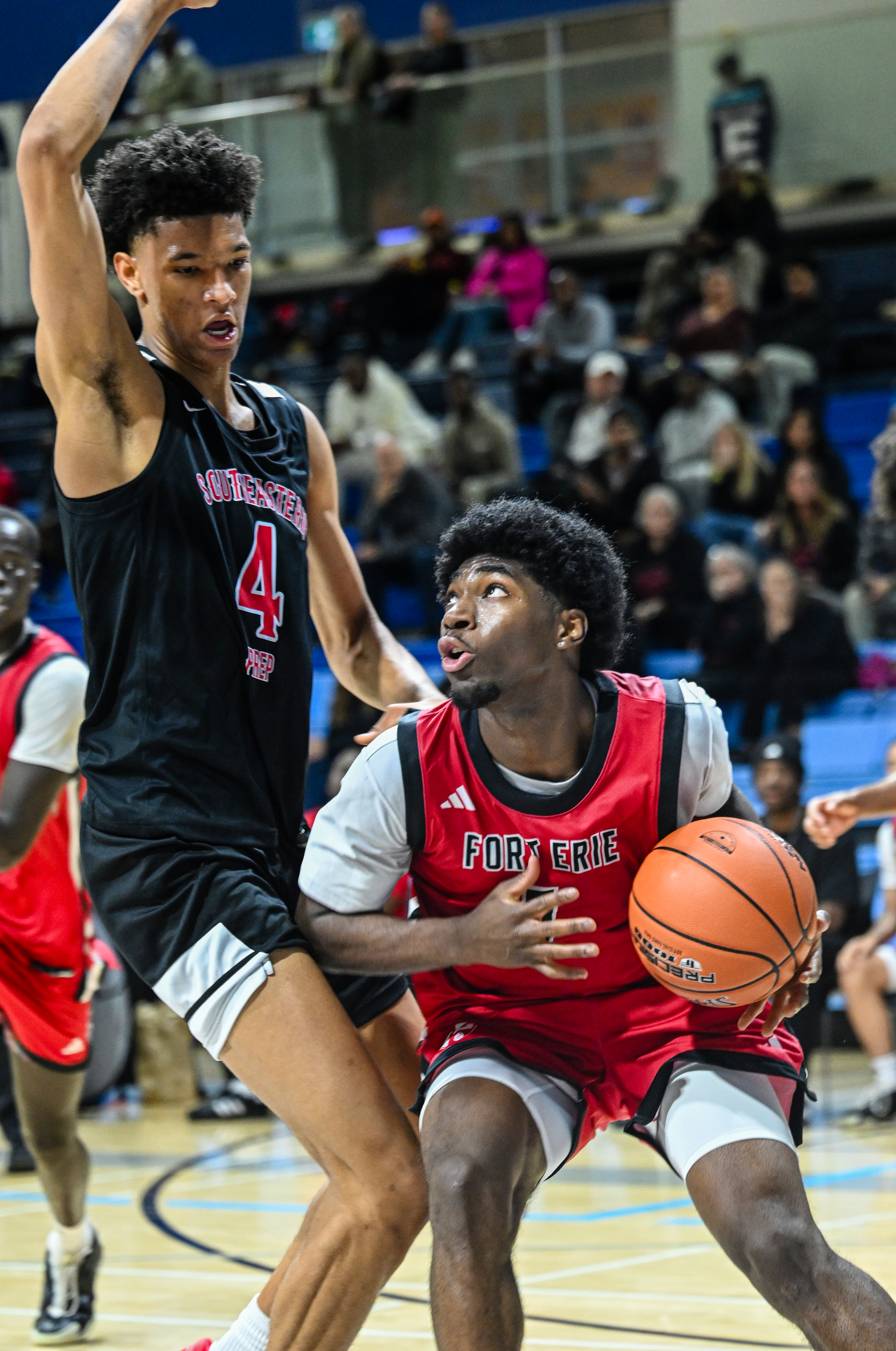 Promis N’landu drives down low against CJ Rosser Jr