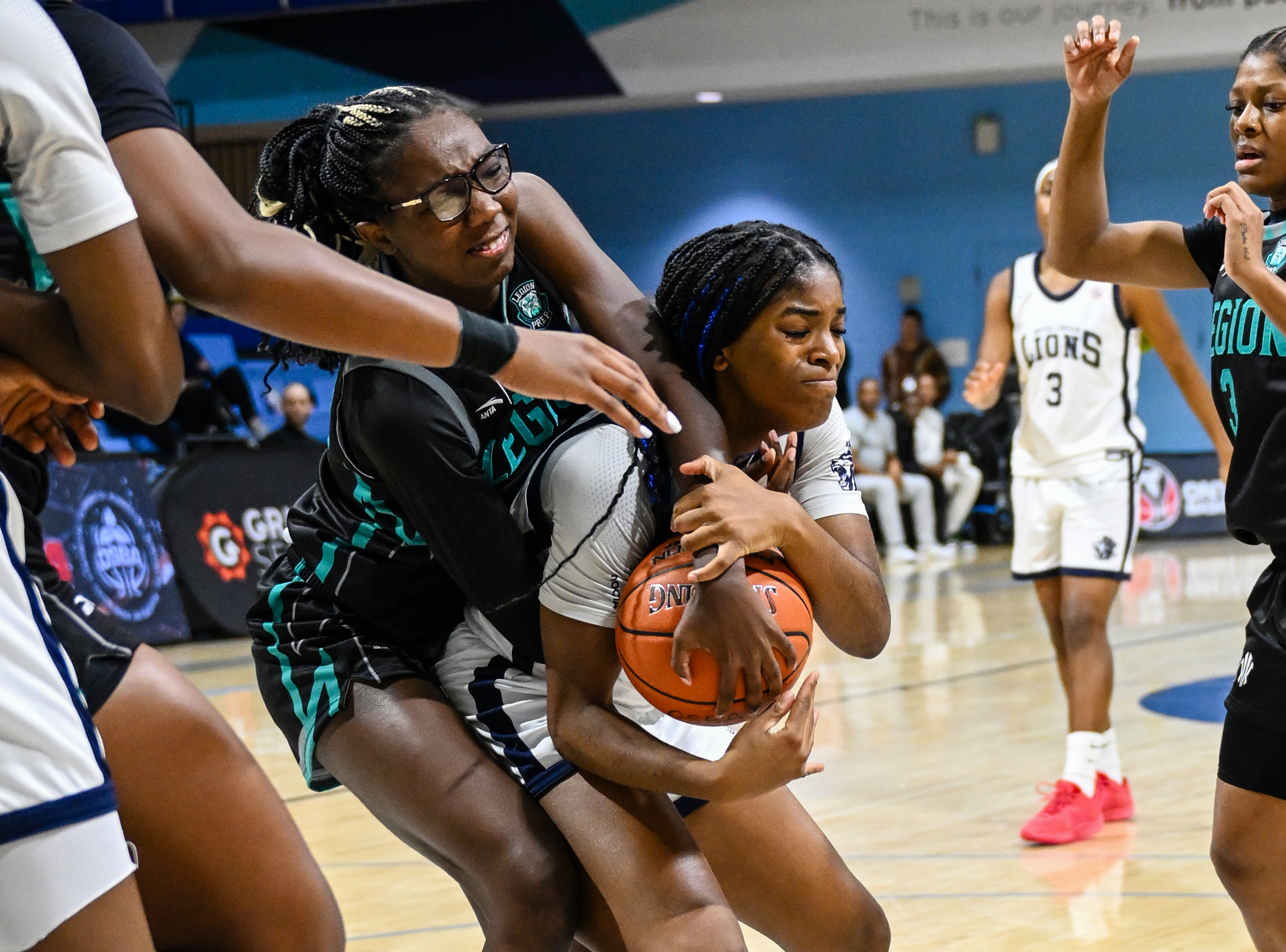 Hayden Hearst (Legion Prep) and Eunicia Salgado (Royal Crown) battle for the ball in the paint