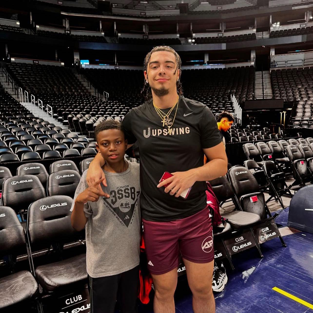 Xaviel Rodriguez with a young HOOPS for HOPE camper