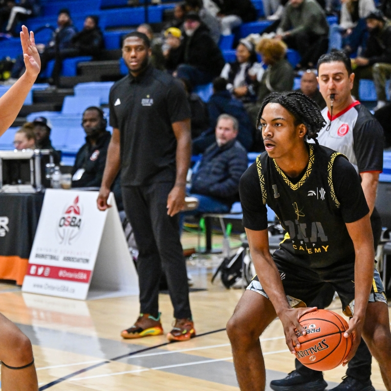 Coach Frank Robinson watches his team